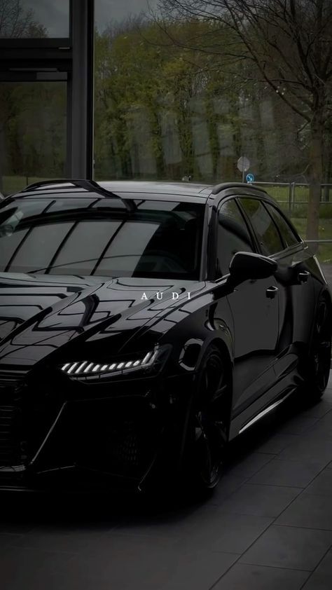 a black sports car parked in front of a building