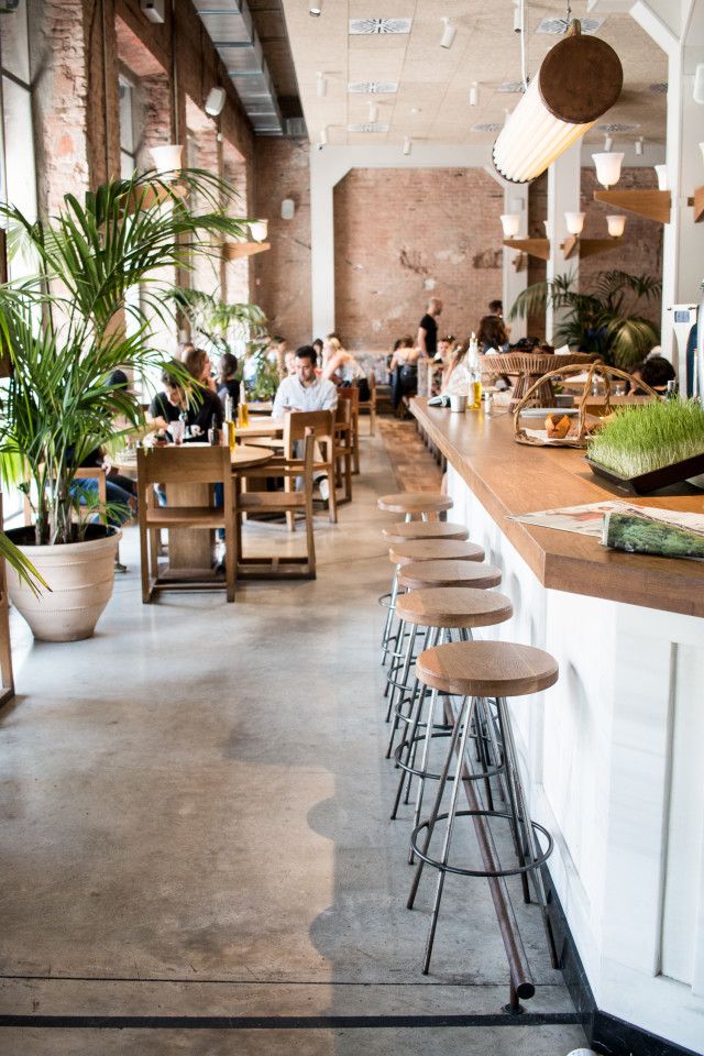 an empty restaurant with lots of people sitting at the bar