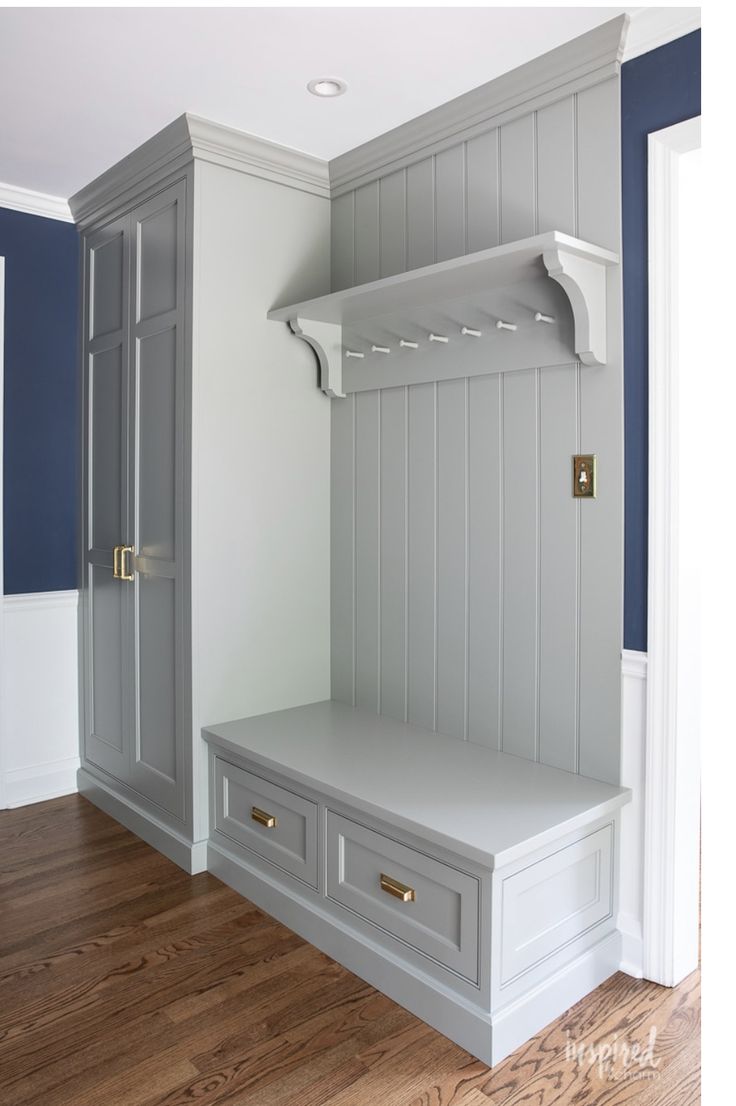 a white bench sitting in the middle of a room