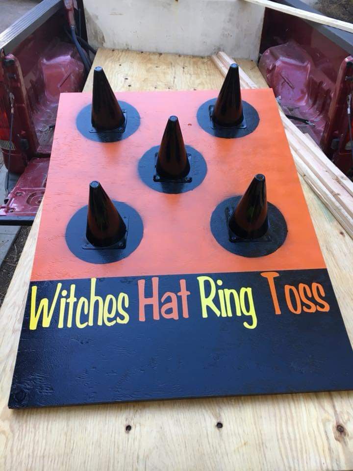 the witches hat ring tosser is on top of a wooden table with plastic cones