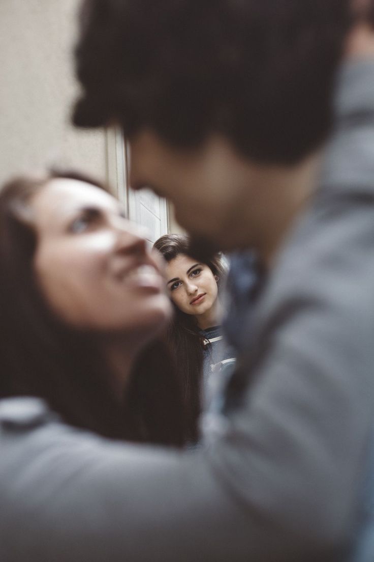 two people are looking at their reflection in the mirror while another person is taking a selfie