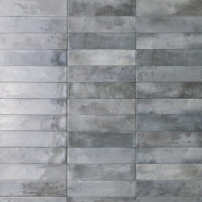 a gray tile wall with vertical lines in the middle