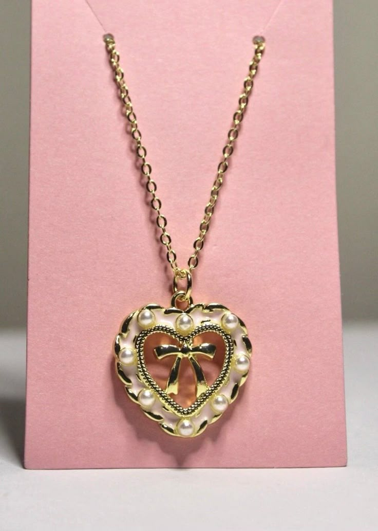 pink heart bow necklace  cute & dainty coquette style necklace  14k gold plated necklace 18, 20, & 24 inches  pendant is approximately 1inchx.75inch by purchasing from Kristen's Kollection's the customer agrees that the use of the jewelry is entirely at the customer's own risk. Warning: jewelry may be a choking hazard, please keep away from children. Final sale. Dainty Coquette, Jewelry Y2k, Cute Jewellery, Sweet Jewelry, Necklace Cute, Coquette Style, Bow Necklace, Pearl Jewelry Necklace, Jewelry Accessories Ideas