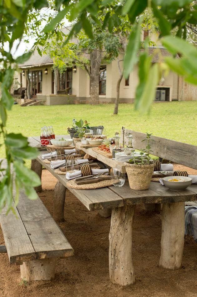 a picnic table set up with plates and utensils