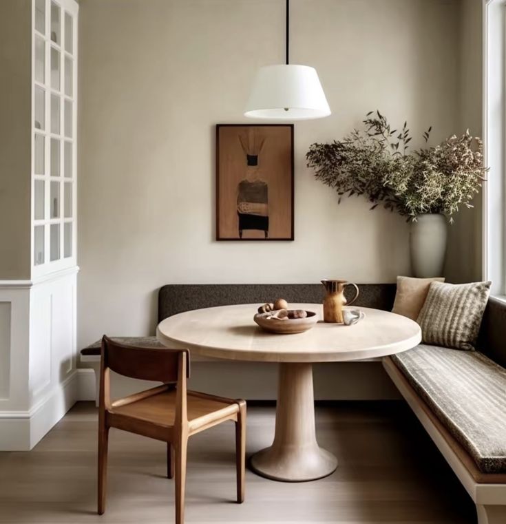 a table and bench in a small room