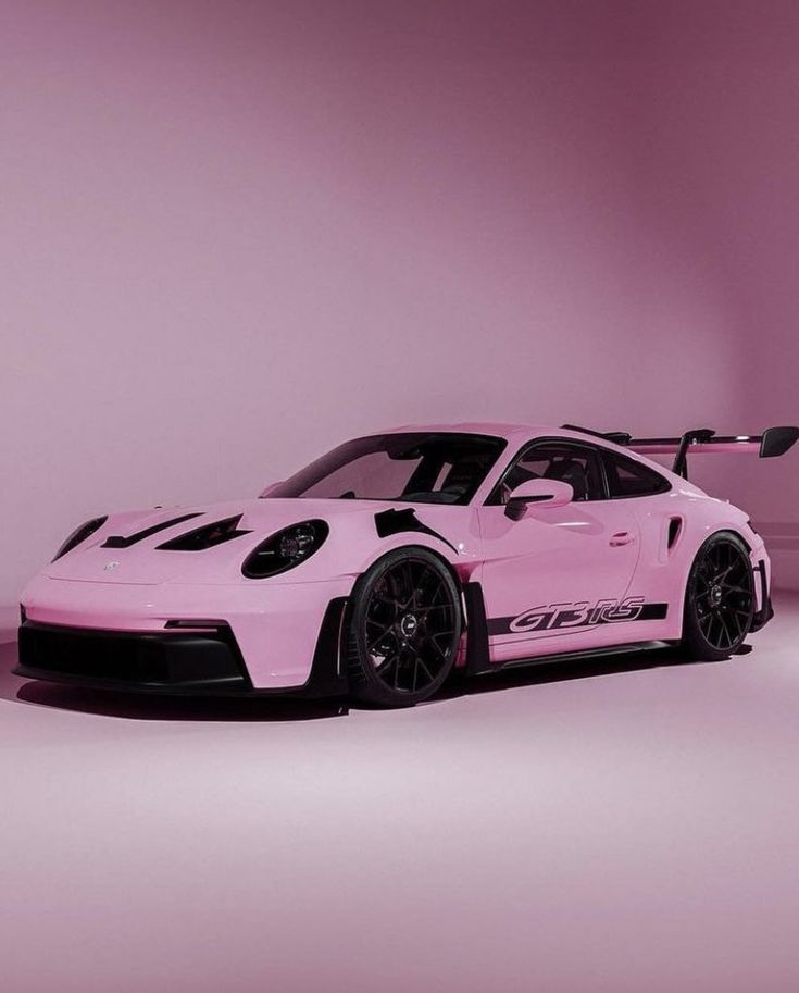 a pink porsche sports car with black stripes