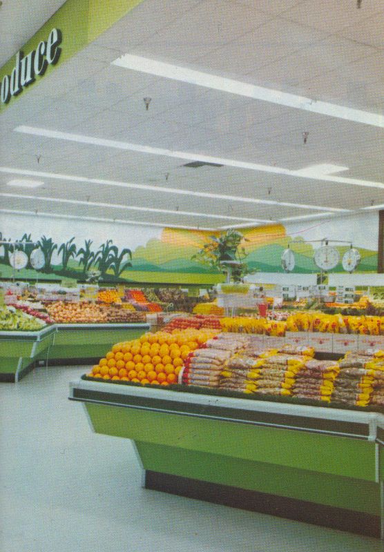 a produce section in a grocery store filled with oranges and other foodstuffs