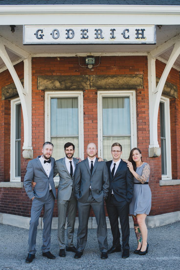 a group of men and women standing in front of a building with the word goederh on it