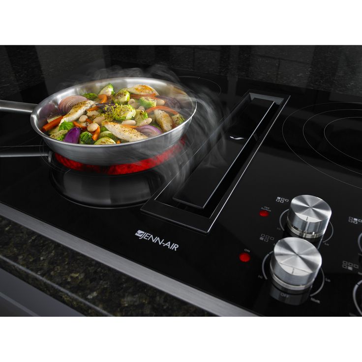 a frying pan on top of a stove with food cooking in the skillet