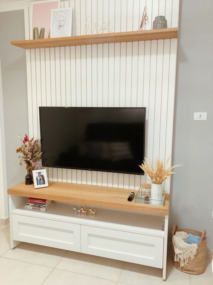 a flat screen tv sitting on top of a white entertainment center