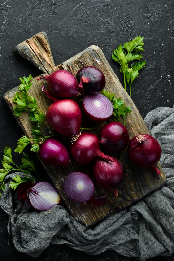 red onions and parsley on a cutting board