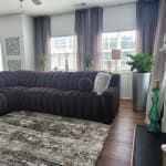 a living room filled with furniture and windows