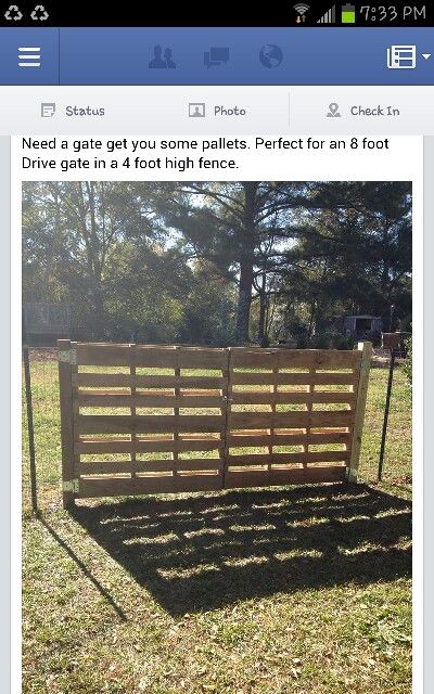 a wooden fence sitting in the middle of a field