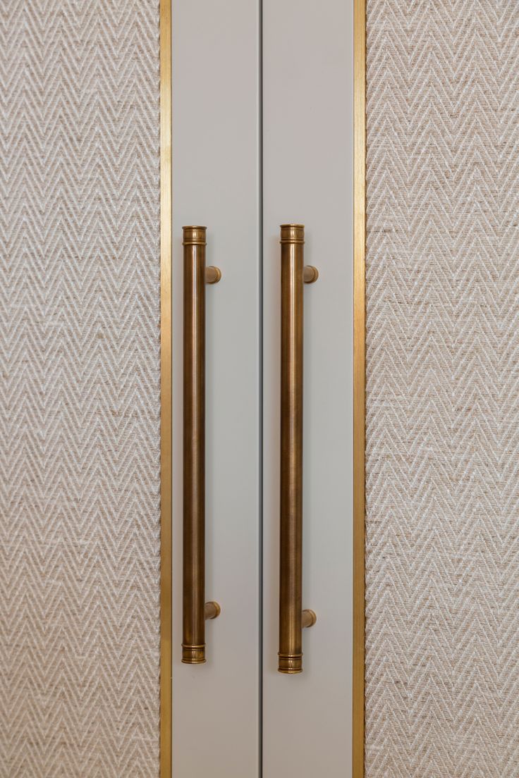 an image of two golden handles on a white door