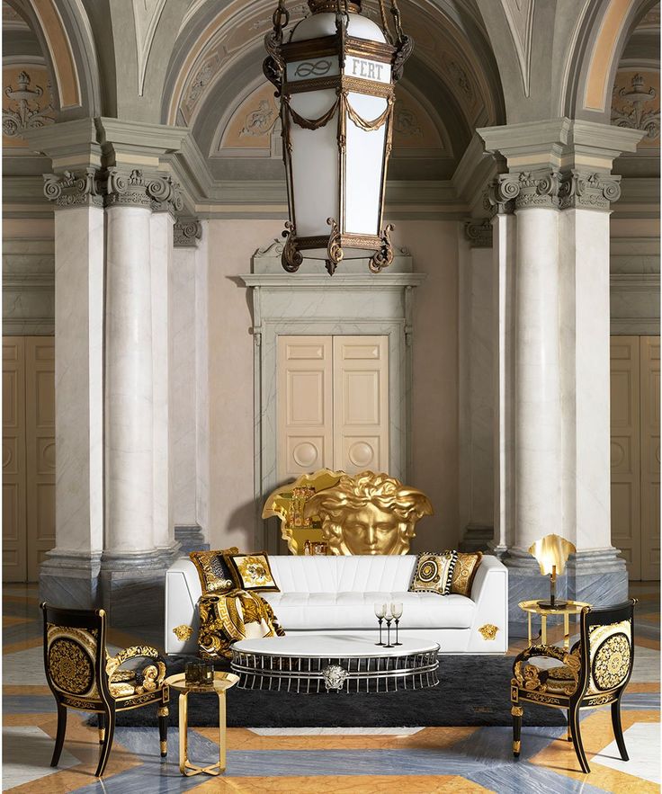 an ornate living room with gold and white furniture