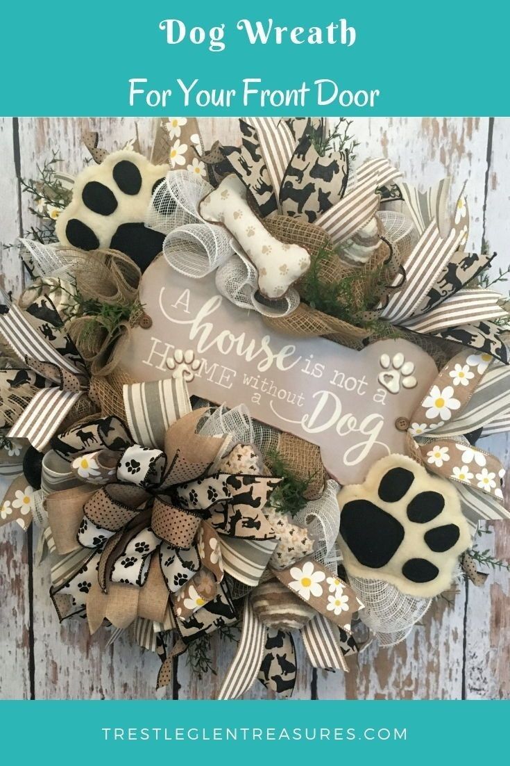 the front door wreath for your front door is decorated with black and white dog paws,