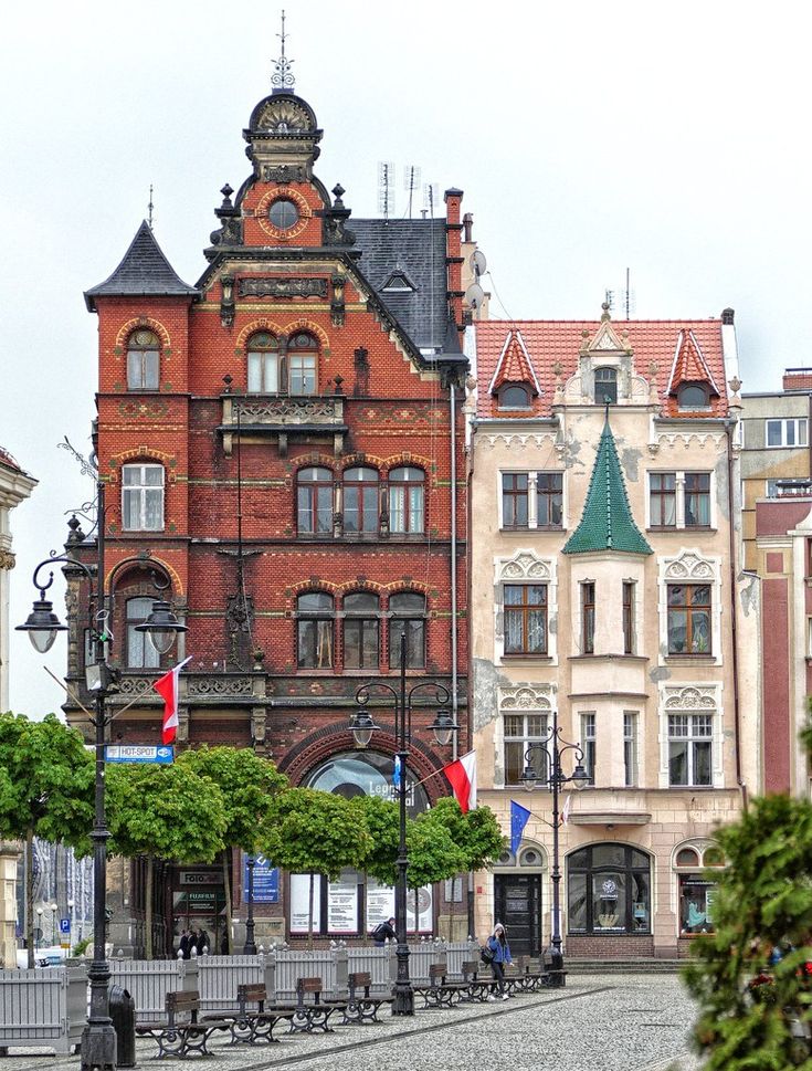 an old brick building with a clock tower in the middle of it's courtyard