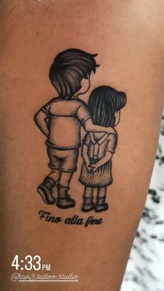 the back of a woman's arm with a tattoo of two children hugging each other