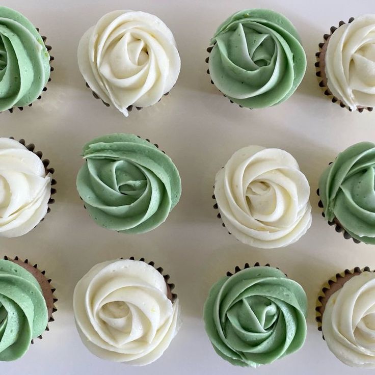 cupcakes with green and white frosting arranged in rows