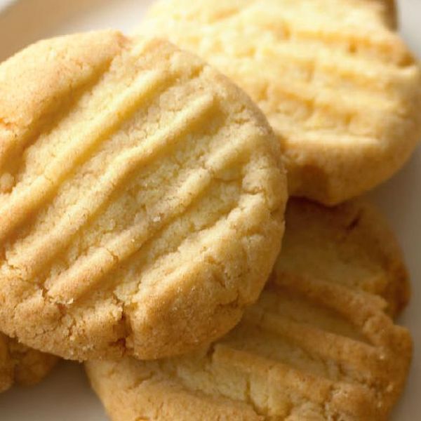 several cookies on a white plate with sprinkles