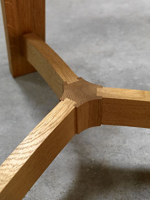 a wooden bench sitting on top of a cement floor