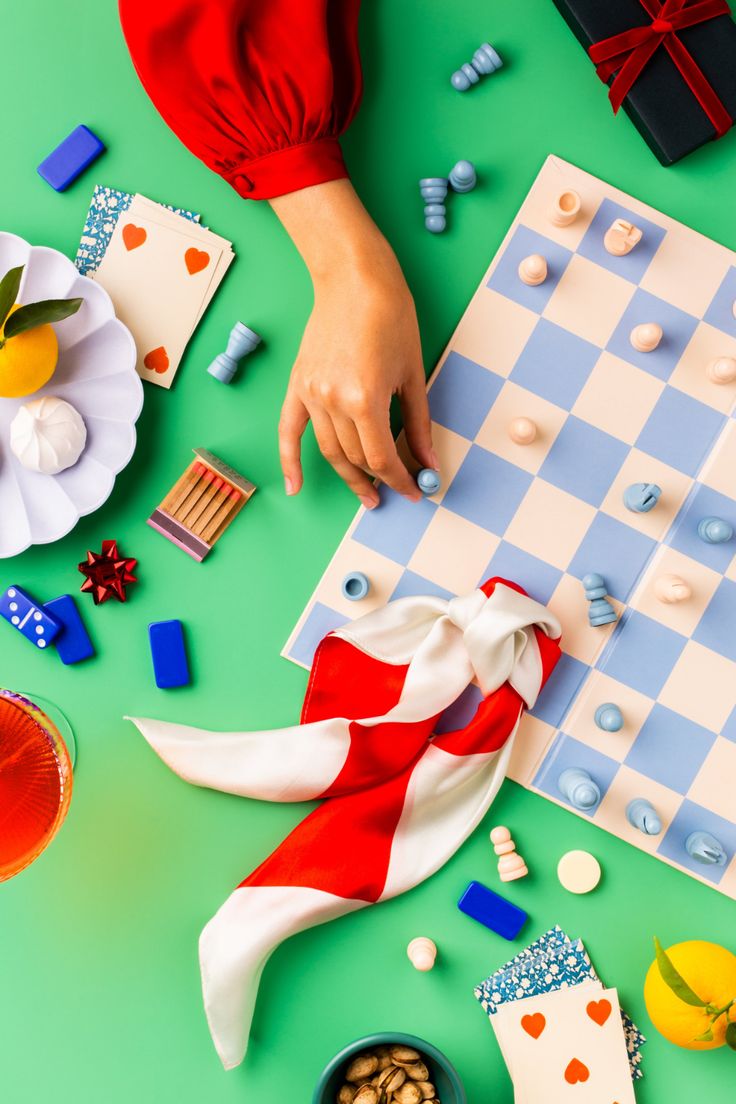 a person is playing chess on a green table with other items and decorations around it