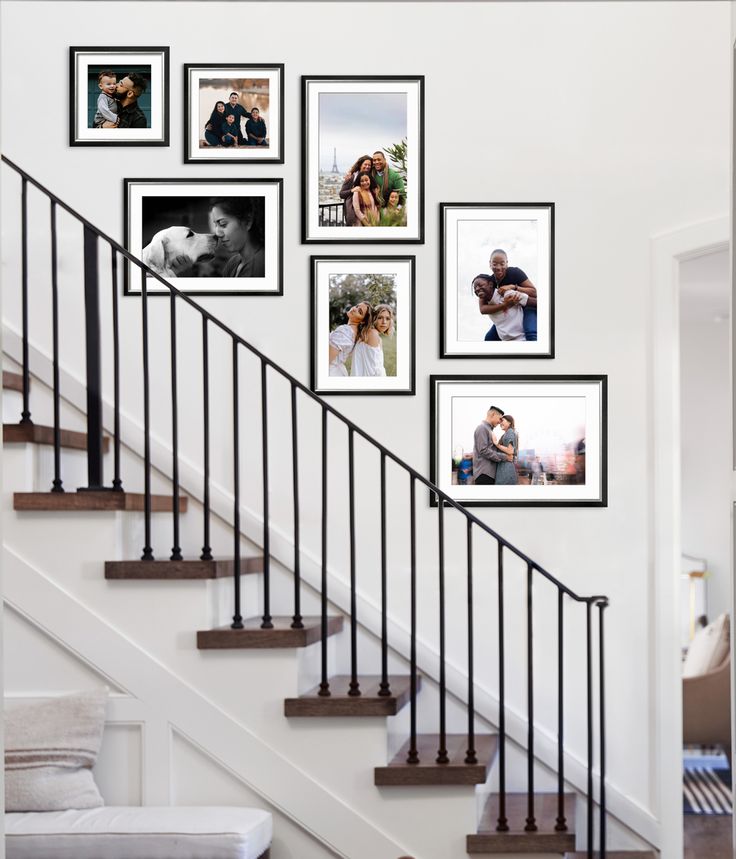 a staircase with pictures hanging on the wall