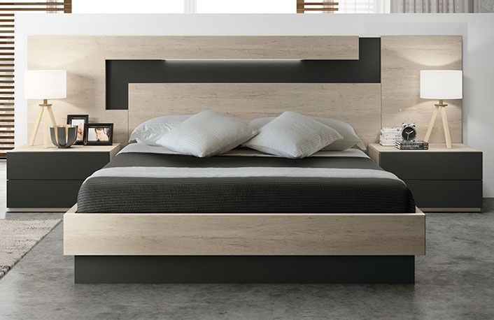 a large bed with two nightstands next to it