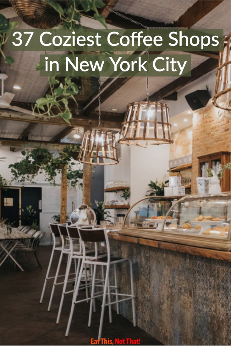 the interior of a coffee shop in new york city, with chairs and tables around it