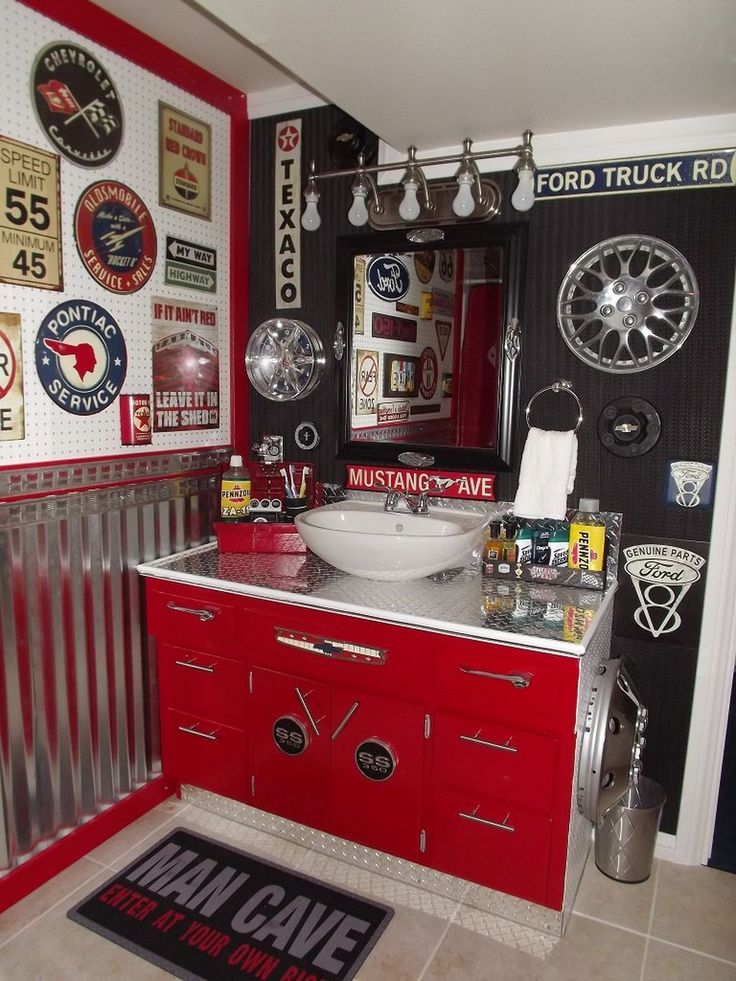 a red and black bathroom with lots of magnets on the wall