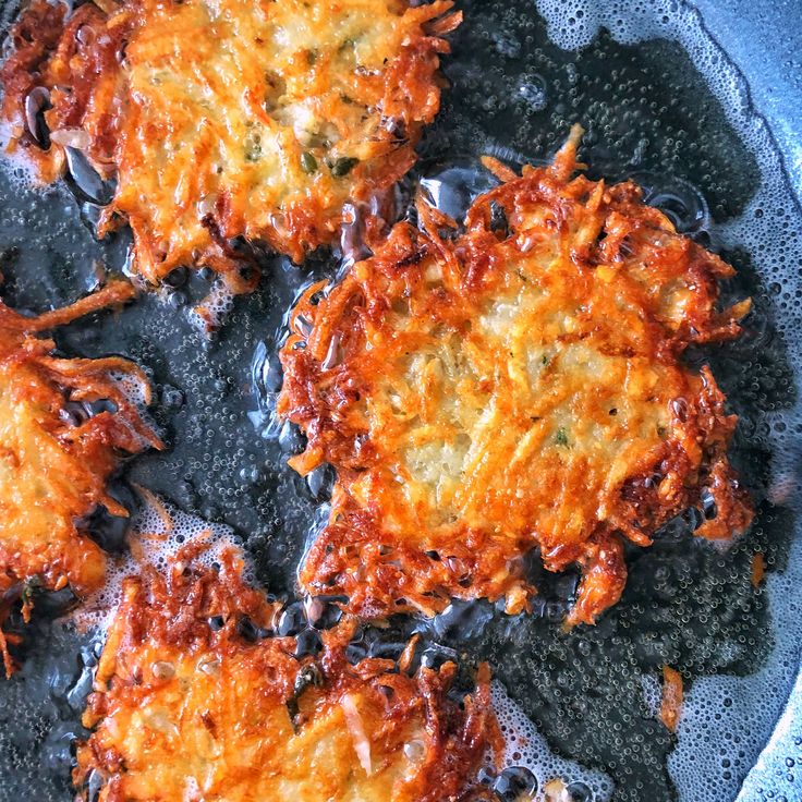 some food is cooking in a frying pan on the stove top and it looks like they have been fried