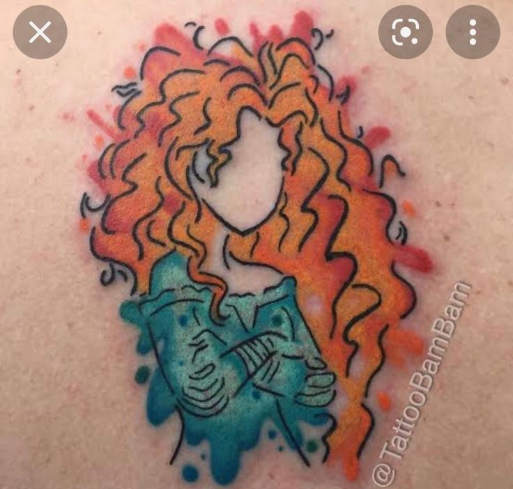 the back of a woman's shoulder with an orange and blue tattoo on it