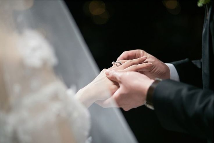 the bride and groom hold hands during their wedding ceremony