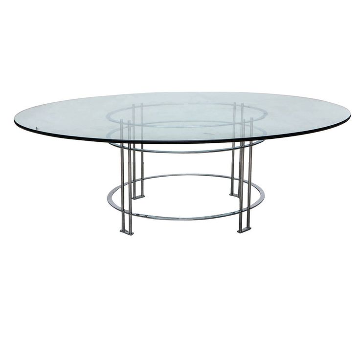 an oval glass table with metal legs