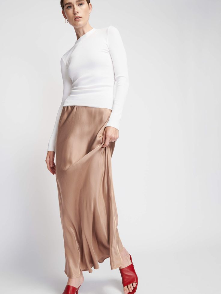 Slip into something silky… With an elastic waist, ultra-flattering fit, and luxe Hammered Satin fabric, it's the maxi skirt of your dreams. (This one comes in Teddy.) | Women's Gaia Skirt in Teddy | Ethical Essentials Chic Full-length Silk Maxi Skirt, Chic Full Length Silk Maxi Skirt, Elegant Satin Skirt With Elastic Waistband, Spring Silk Maxi Bottoms, Full Length Silk Maxi Skirt For Spring, Elegant Maxi Dress With Flowy Skirt And Elastic Waistband, Chic Full Length Bias Cut Maxi Skirt, Elegant Fitted Maxi Skirt With Elastic Waistband, Elegant Wide Leg Maxi Skirt With Elastic Waistband