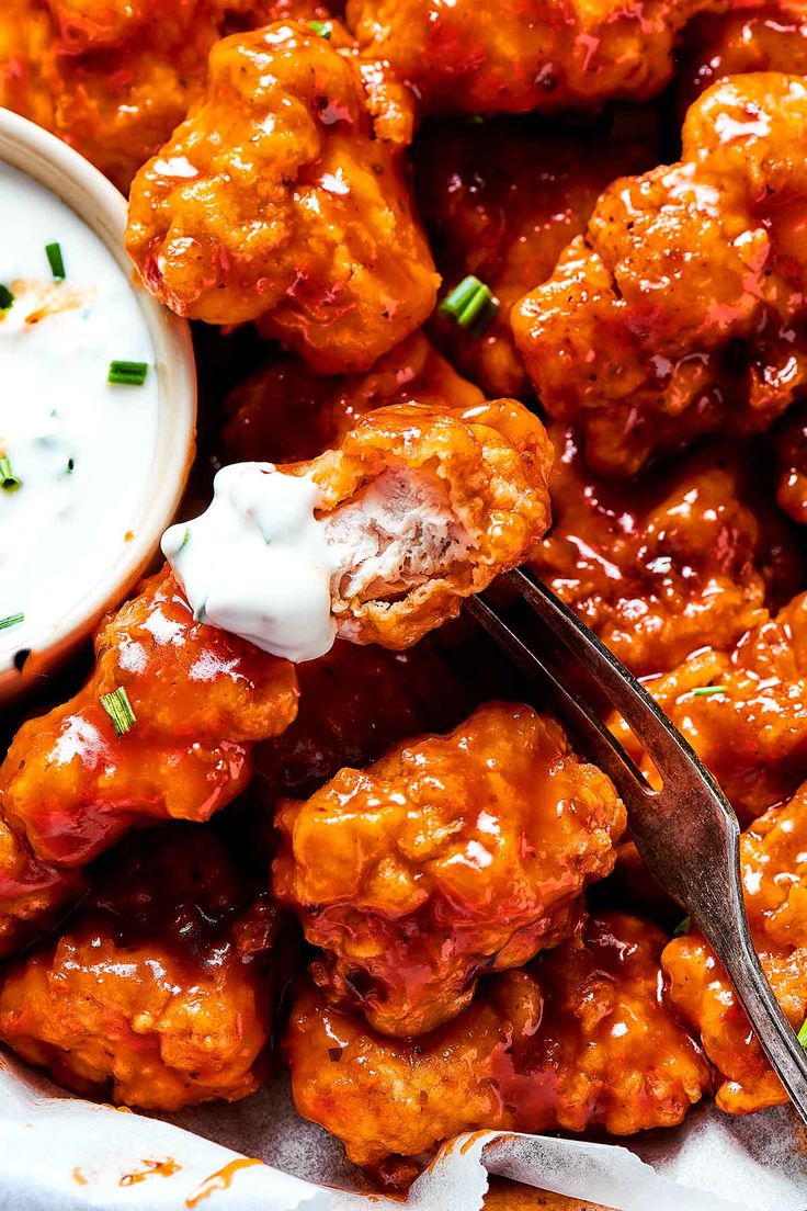 a plate full of buffalo wings with ranch dressing