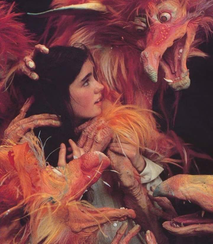 a woman is surrounded by monster like creatures