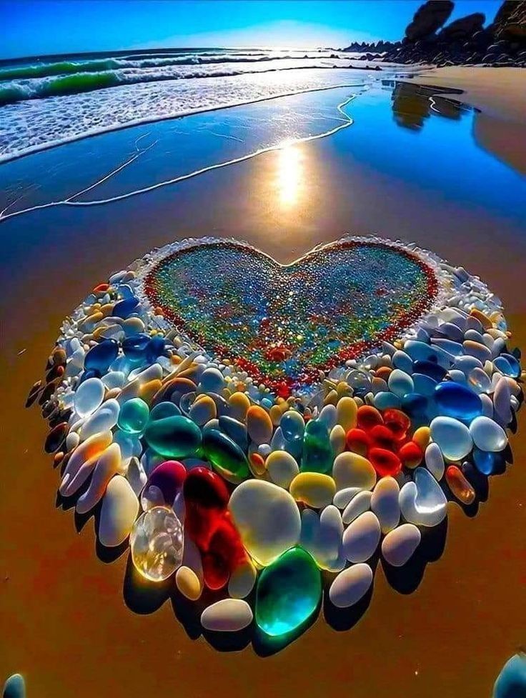 a heart made out of sea glass on the beach