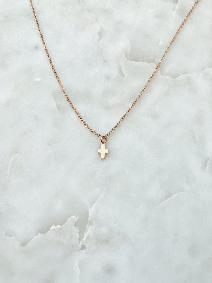 "This is a delicate tiny 14/20 gold or rose gold fill cross on a 14/20 gold or rose fill chain. It is perfect for layering or can be worn alone as it is here. Pictured: First - Gold, 14\" Second - Gold, 16\" Matching Bracelet: https://www.etsy.com/listing/240565680/tiny-cross-charm-bracelet-on-a-1420-gold?ref=shop_home_active_11" Dainty Cross Necklace For Everyday Wear, Minimalist Rose Gold Cross Pendant Jewelry, Minimalist Rose Gold Cross Pendant, Minimalist Cross Charm Necklace With Delicate Chain, Simple Necklace With Delicate Chain And Cross Pendant, Dainty 14k Gold Cross Necklace With Delicate Chain, Dainty 14k Gold Cross Necklace, Dainty Charm Necklace With Cross Pendant And Adjustable Chain, Dainty 14k Gold Cross Pendant Charm Necklace