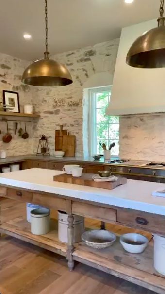 a kitchen with an island and two hanging lights