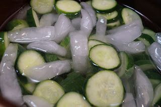 sliced cucumbers are being prepared in a bowl