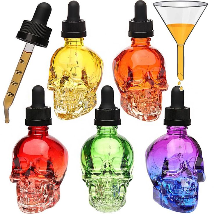 four different colored skull bottles next to each other with a yellow liquid in the middle