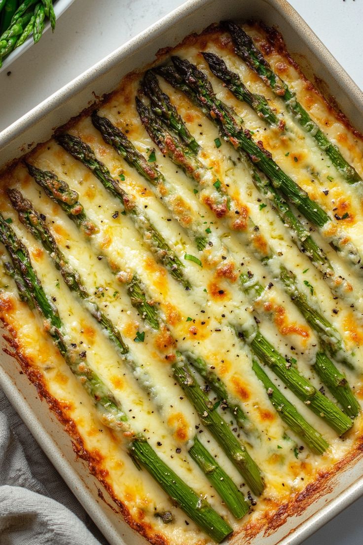 a casserole dish with asparagus and cheese