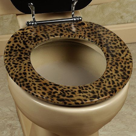 an animal print toilet seat cover with the lid up