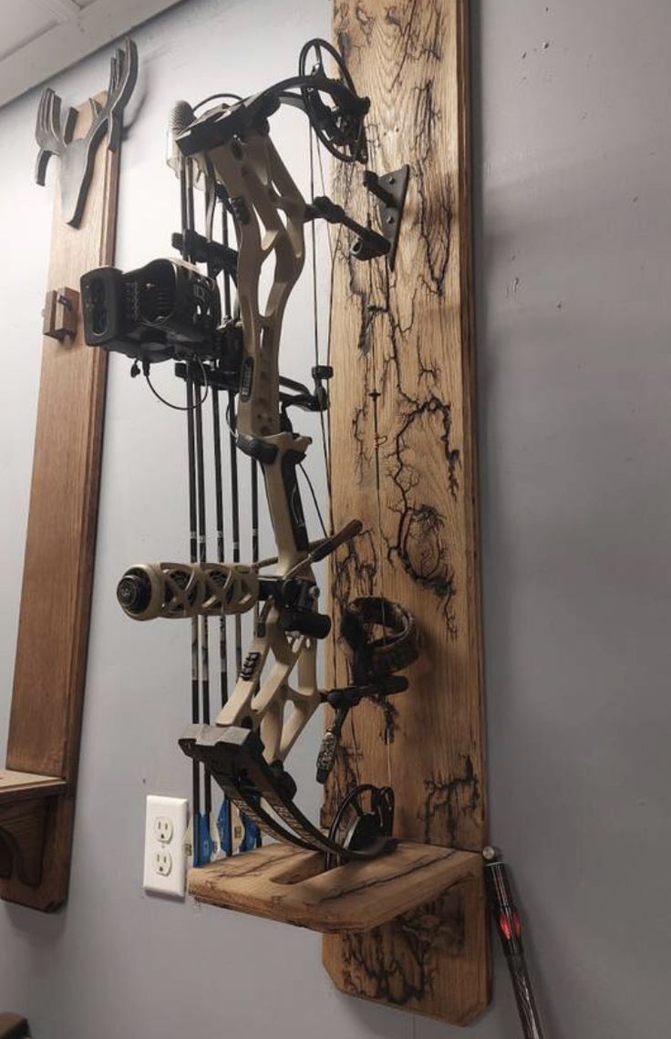 a wall mounted archery bow rack in a room