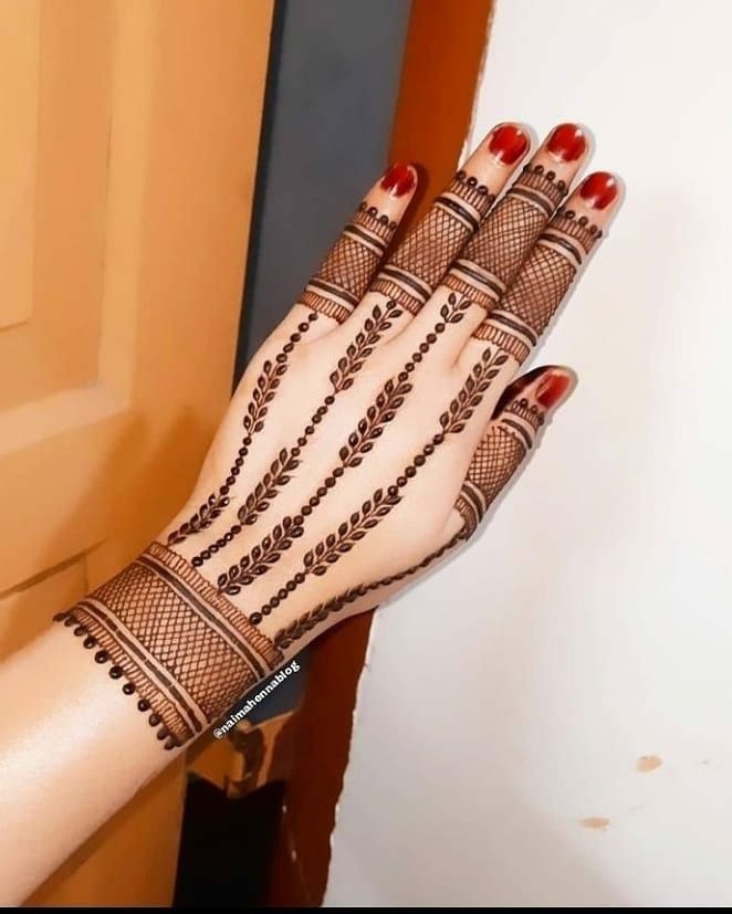 a woman's hand is decorated with hennap and beaded bracelets