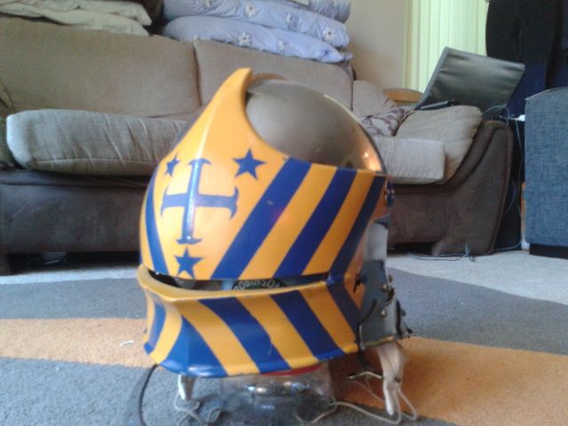 a helmet sitting on the floor in front of a couch