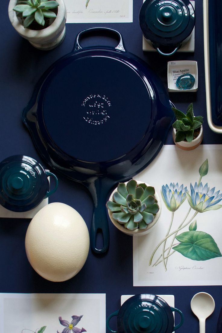 a blue table topped with plates and bowls