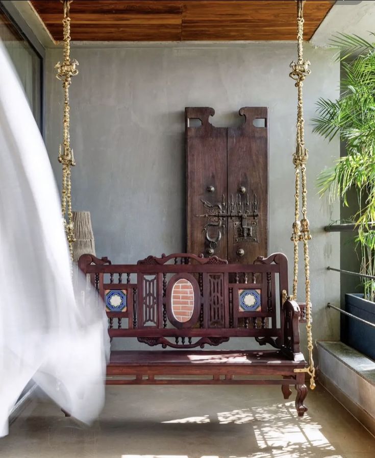 a wooden swing sitting next to a window