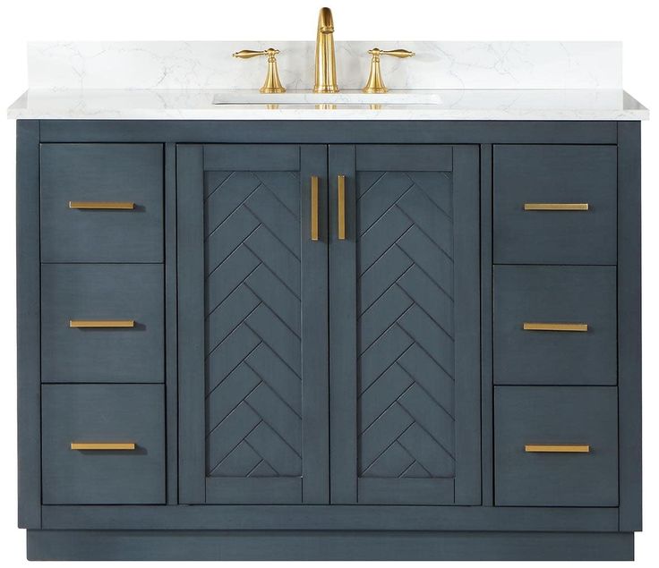 a bathroom vanity with marble top and gold handles on it's doors, along with two faucets